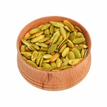 Roasted pumpkin seeds in wooden bowl high angle view isolated on white background