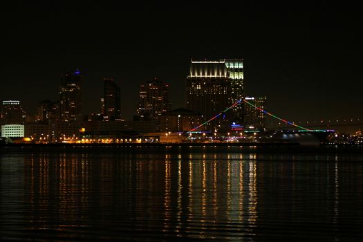 The skyline of San Diego at night with reflection in the water.