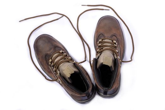 New hiking boots posing on white background. View from above.