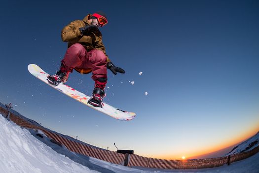 Young man snowboarding in the mountains.