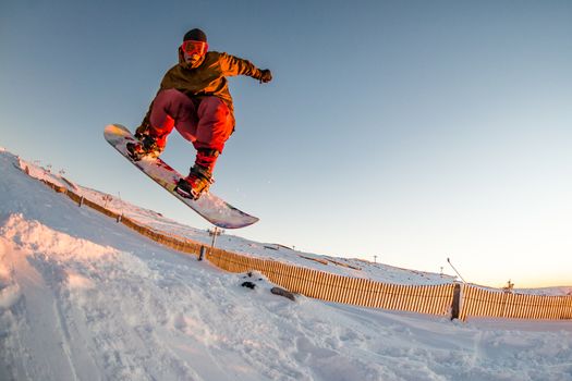 Young man snowboarding in the mountains.