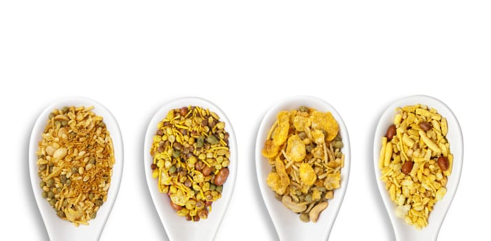 Dry roasted Indian snack mix in a big spoon, isolated
