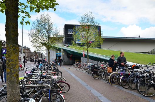 Amsterdam, Netherlands - May 6, 2015: Tourist visit Stedelijk Musem in Amsterdam located in the museum park, Netherlands on May 6, 2015