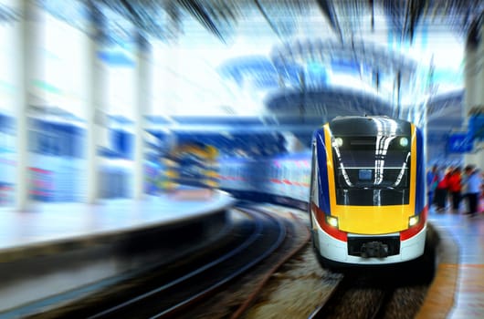 Fast moving train leaving station platform