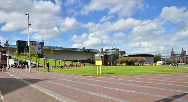 Amsterdam, Netherlands - May 6, 2015: Tourist visit museum park in Amsterdam, Netherlands on May 6, 2015. Museum park is home to the three major and most important museums in Amsterdam, the Rijksmuseum, the Stedelijk Museum of Modern Art and the Van Gogh Museum.