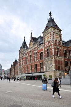 Amsterdam, Netherlands - May 7, 2015: People at Amsterdam Central Train Station on May 8, 2015 in Amsterdam, Netherlands. Amsterdam Central Station is used by 250,000 passengers a day.