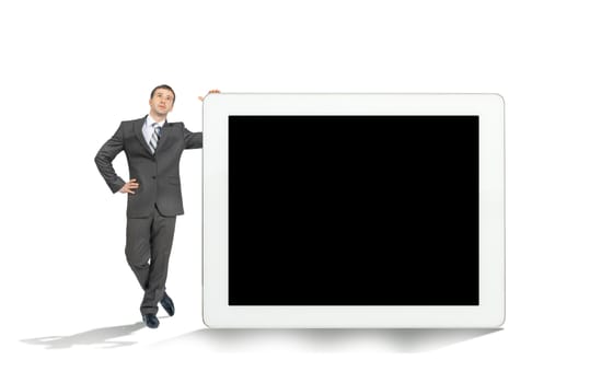 Businessman near big tablet with blank screen isolated on white background, technology concept