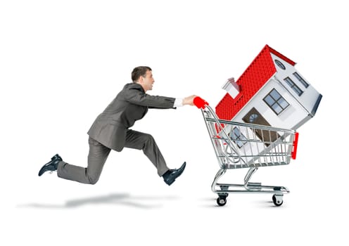 Businessman pushing shopping cart with house isolated on white background