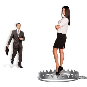 Businessman with woman in bear trap isolated on white background