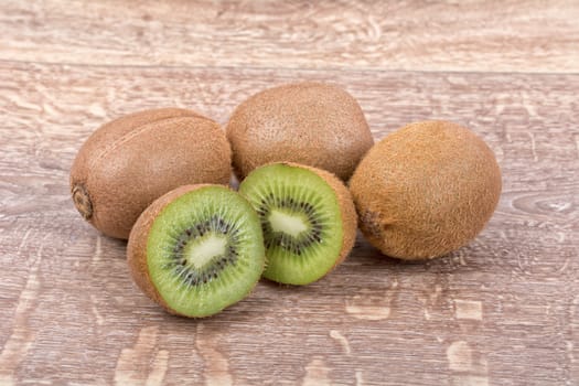 Ripe kiwi on a brown wooden background