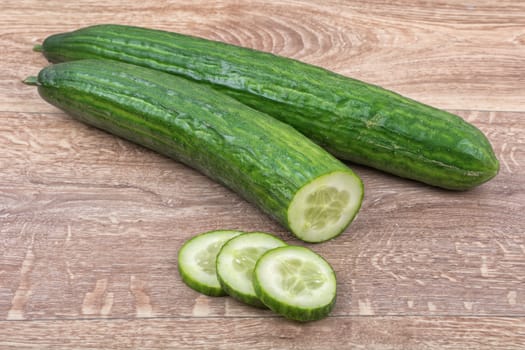 Cucumbers on a brown wooden background