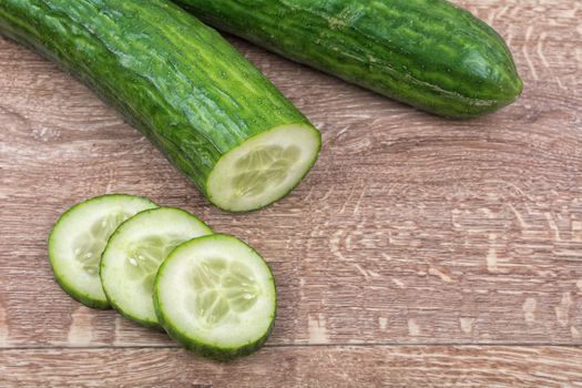 Cucumbers on a brown wooden background