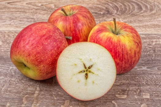 Ripe apples on a brown wooden background