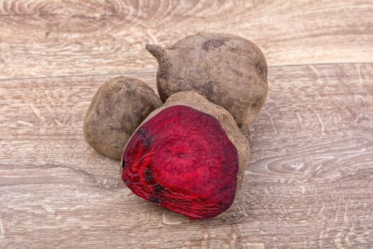 The red beets on a brown wooden background