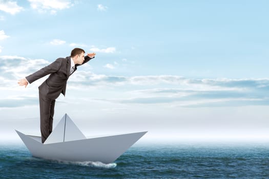 Businessman in paper boat in blue sea, business concept