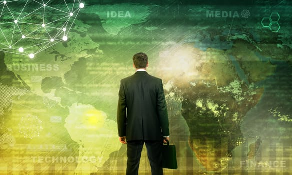 Businessman in front of world map with graphical charts, technology concept