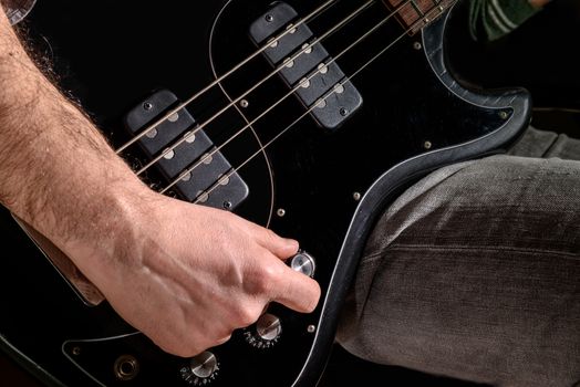 Detail of an electric guitar. Hands moving on the keyboard. Close up. Score and guitar.