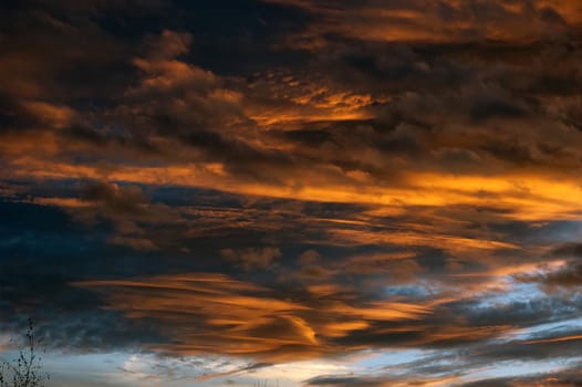 Nice clouds at sunset with orange black color.
