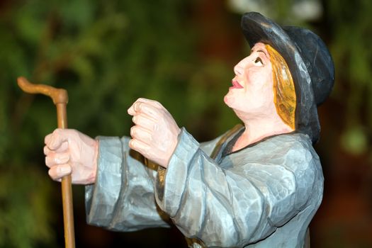 Colored wood statuette of sheep herder.
