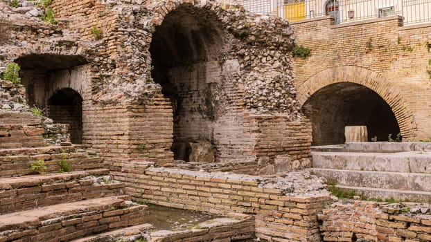 A detail of the ruins of Odeon, the ancient greek theater of taormina, in sicily, landscape cut.