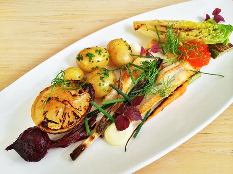 Gourmet dish with grilled perch fish and vegetables. Scandinavian cuisine.