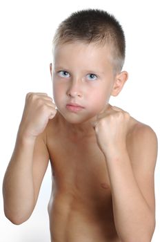  serious and determined young boy wearing boxing gloves and looking at the camera. Isolated on white