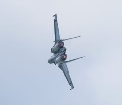 Rear shot of Russian, twin engined, supersonic jet fighter during an air show performance.