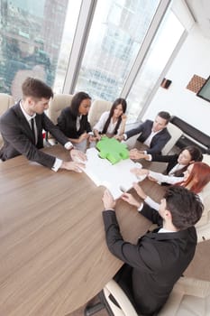 Group of business people assembling jigsaw puzzle and represent team support and help concept in office