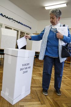 SLOVAKIA, Bratislava: A woman casts her ballot in Gymnazium Ladislava Sàru polling station in Bratislava, Slovakia on March 5, 2016 on the first round of Slovak legislative election.