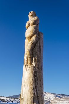 Wooden sculpture of a Pregnant woman at the park of lost souls (Parko Psychon) at Parnitha mountain.