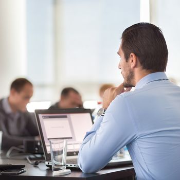 Corporate business meeting in office. Business executive giving instructions to his colleagues. Explaining business plans to employees. Business team concept. Business and Entrepreneurship. 