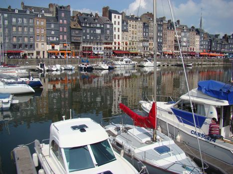 Honfleur, France - May 9 2010: Typical Facades and Boats on the Port of Honfleur in the Calvados department in northwestern France     