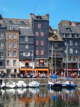 Honfleur, France - May 14 2010: Typical Facades and Boats on the Port of Honfleur in the Calvados department in northwestern France