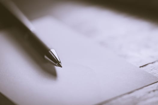 Blank paper on wood table with notebooks on wood table with vintage filter effect