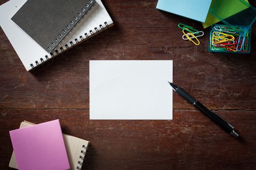 Notepad with blank area for text or message on wood table with low key scene