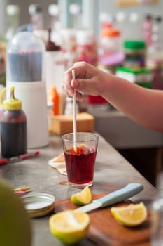 The process of making Thai lemon tea. Woman right hand stir hot tea to dissolve and mix ingredients together.