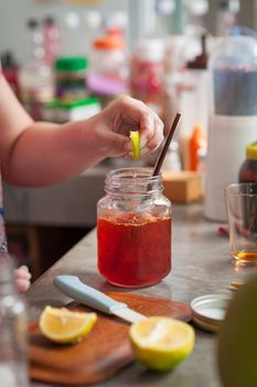 The process of making Thai lemon tea. Woman left hand squeeze lemon into cold tea