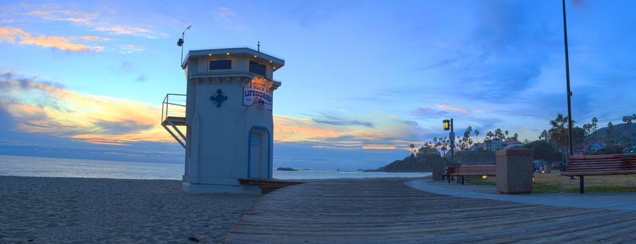 Lifeguard on boardwalk at Main beach in Laguna Beach, Southern California at sunset