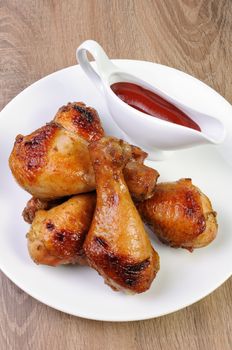 Baked chicken leg with tomato sauce on a plate