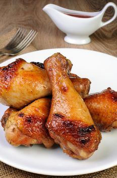 Baked chicken leg with tomato sauce on a plate