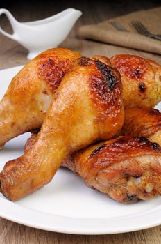 Appetizing baked chicken leg on a plate close-up