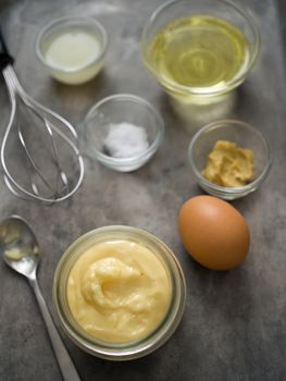 close up of rustic homemade mayonnaise and ingredient