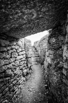 Trench dug in the rock dating back to World War I located on the Italian alps.