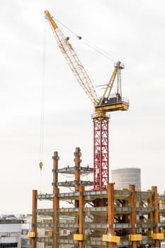 Big building being constructed with crane on top