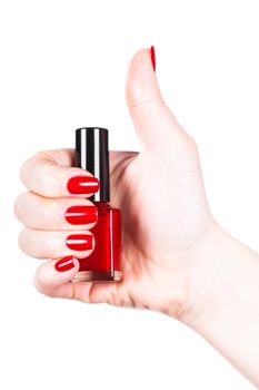 Red nail polish in a hand on white background