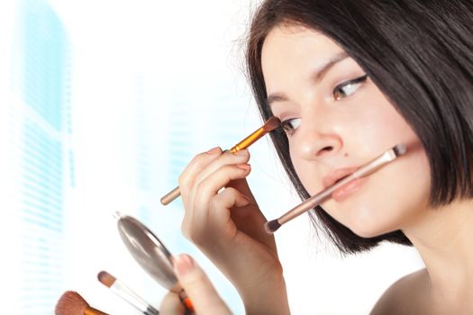 the girl does make-up on a white background