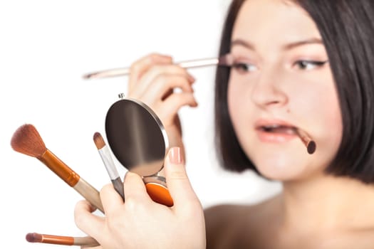 the girl does make-up on a white background