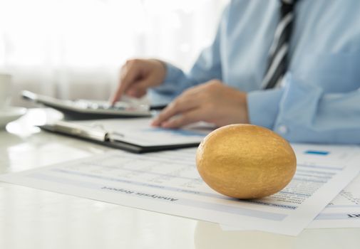 closeup golden eggs on desk in office. finance concept