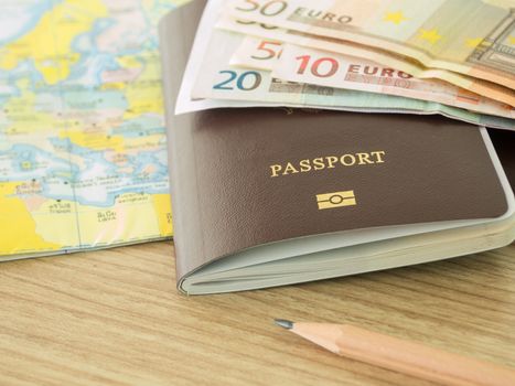 closeup passport on world map with banknote