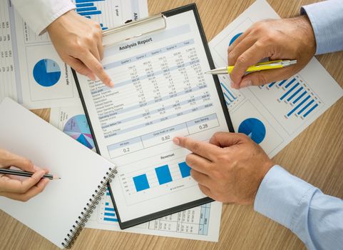 Businessmen are analyzing the data to business planning. top view.
